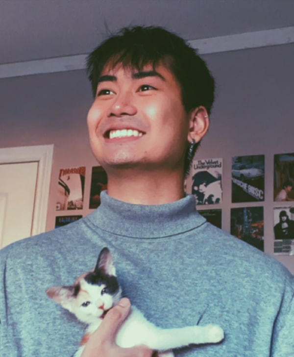 Picture of Joey holding a kitten.